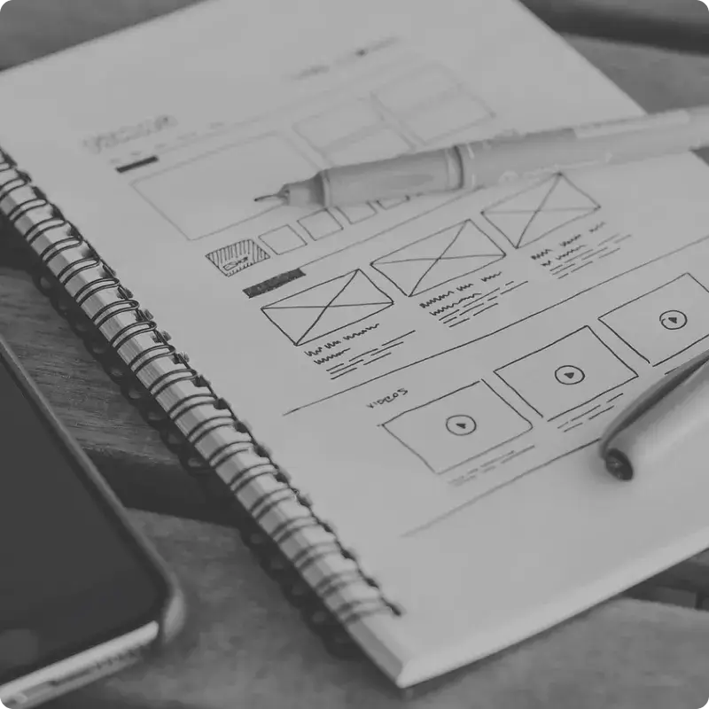 Sketched website wireframe on a notebook square