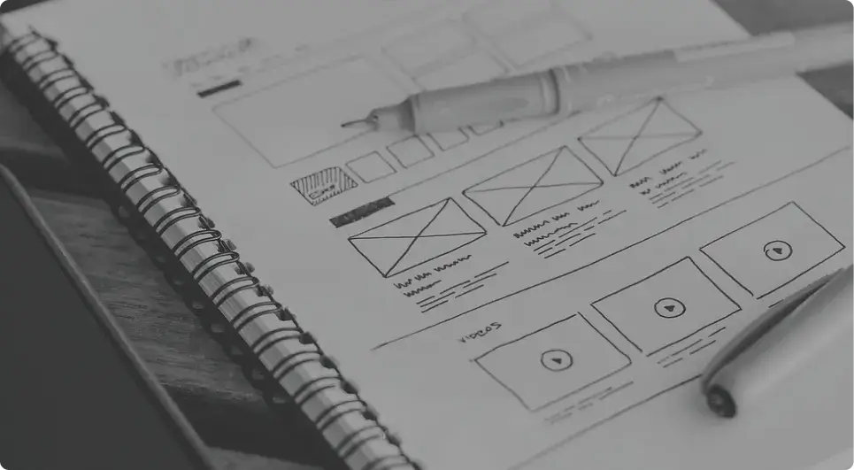 Sketched website wireframe on a notebook