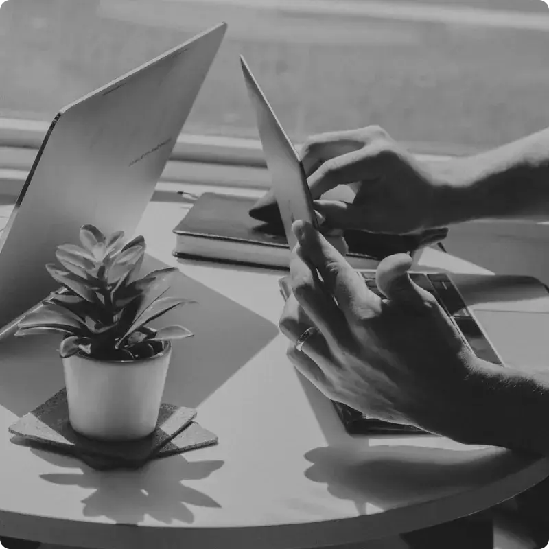 Square image of working with laptops at a coffee shop